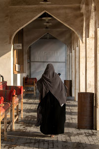 Women in abaya walking in souq waqif back view no face