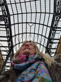 Low angle view of woman under covered bridge