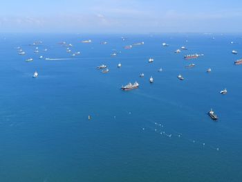 High angle view of cargoships in sea against sky