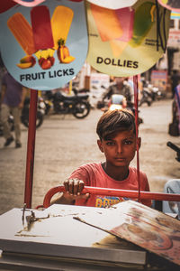 Side view of boy selling icecream at market 