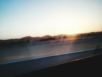 Scenic view of landscape against clear sky at sunset