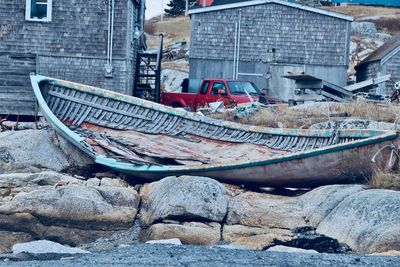 Abandoned boats moored at harbor