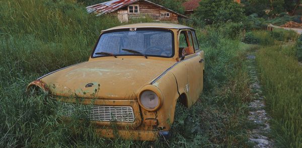Abandoned car on field