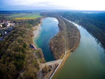 High angle view of river by city against sky