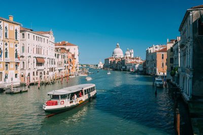Ferry moving in grand canal with santa maria della salute in background