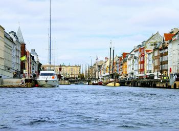 Buildings by sea against sky in city