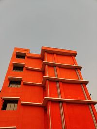 Low angle view of red building against clear sky