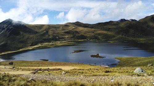 Scenic view of lake and mountains against sky