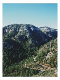 Scenic view of mountains against clear blue sky