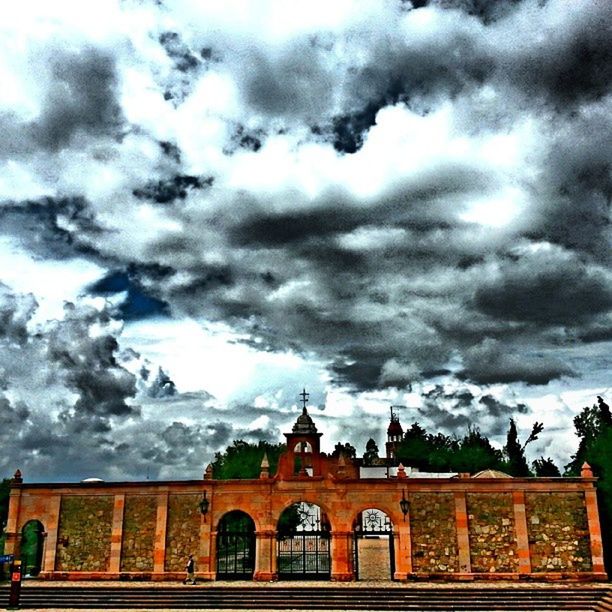 cloud - sky, sky, cloudy, architecture, built structure, building exterior, weather, low angle view, cloud, overcast, arch, storm cloud, window, day, outdoors, no people, nature, house, religion, dramatic sky