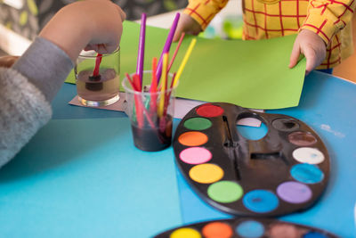 Hands of children preparing to draw