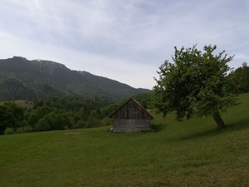 Built structure on field against sky