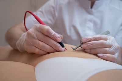 Midsection of woman holding hands