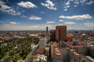 High angle view of cityscape against cloudy sky