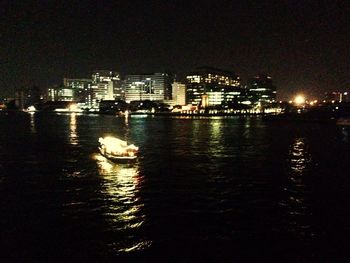Boats in river at night