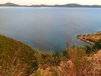 High angle view of calm sea against mountain range