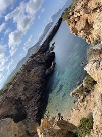 High angle view of rocks in sea against sky