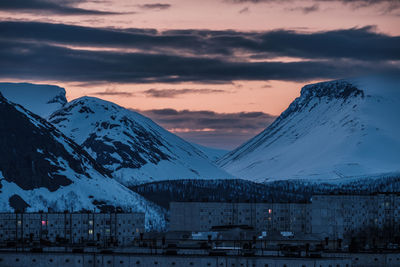 Scenic view of snowcapped mountains against sky during sunset