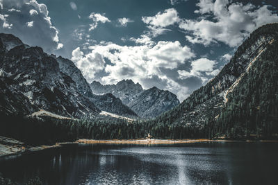 Scenic view of lake by mountains against sky