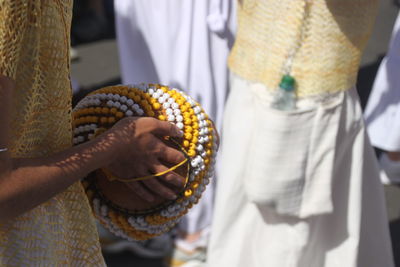 Midsection of man playing calabash