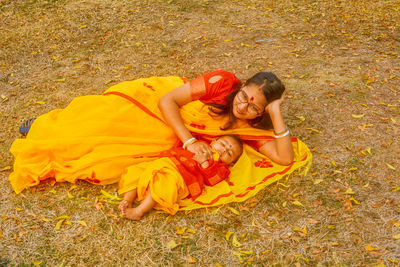 High angle view of woman sitting on field