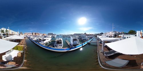 Sailboats moored at harbor