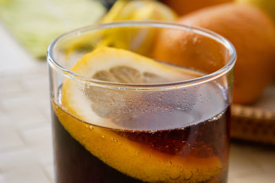 Close-up of beer, soft drink in glass on table