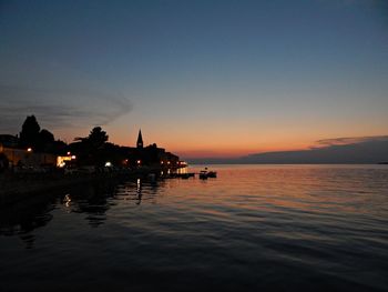 Silhouette of swimming pool in sea against sky