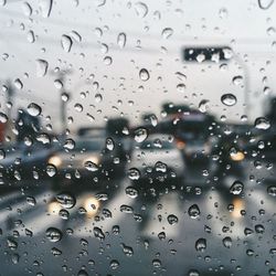 Close-up of water drops on car window