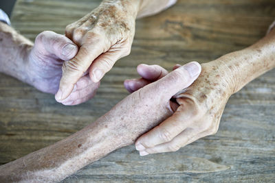 Senior couple holding hands, close-up