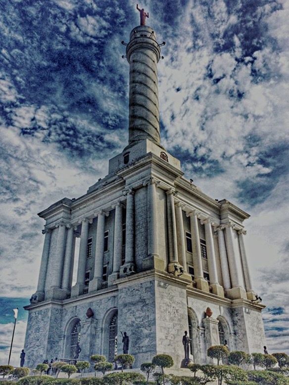 architecture, built structure, building exterior, tourism, travel destinations, famous place, history, low angle view, travel, architectural column, sky, tower, tourist, facade, cloud - sky, tall - high, memories, the past, city, arch, column, outdoors, monument, vacations, architectural feature, international landmark, capital cities, leaning tower of pisa, culture, lawn, day, city life, ancient
