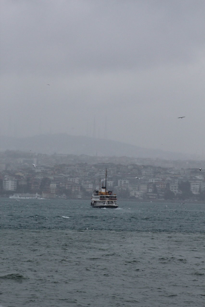 nautical vessel, sea, weather, water, waterfront, no people, fog, sky, transportation, mode of transport, day, outdoors, sailing, nature, architecture, beauty in nature, city