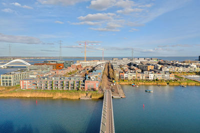 High angle view of bridge over river and buildings against sky