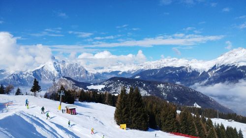 Scenic view of snowcapped mountains against blue sky