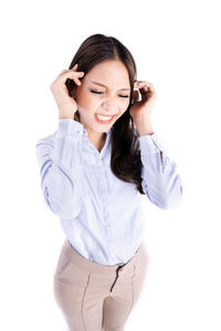 Smiling young woman standing against white background