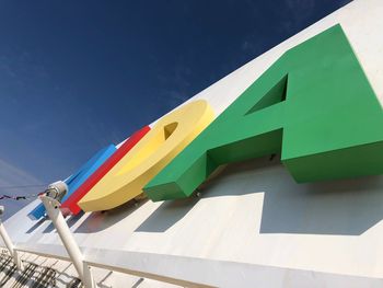 Low angle view of flag against blue sky