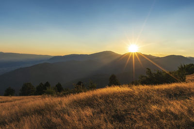 Scenic view of mountains against sky during sunset