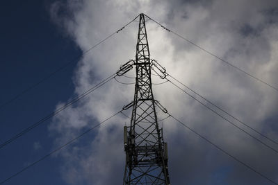 Low angle view of electricity pylon against sky