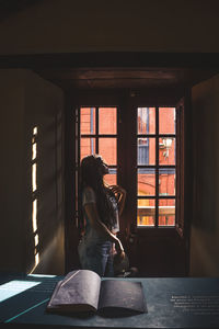 Woman looking at window