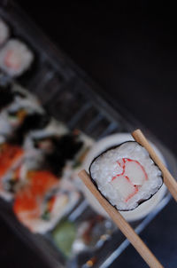 Close-up of chopsticks with sushi