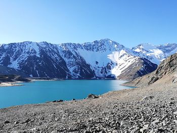 Scenic view of snowcapped mountains against clear blue sky