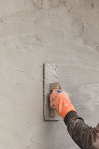 High angle view of man working on concrete wall