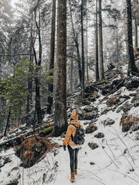 Full length of woman standing on snow covered land