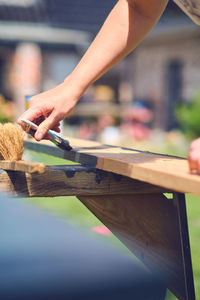 Cropped hand of man working on wood