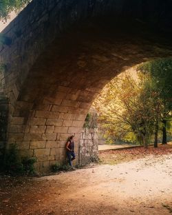 Man standing by tree