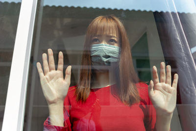 Portrait of woman in glass window