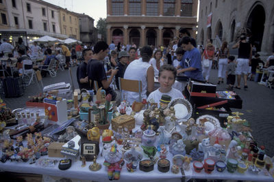 People at market stall in city