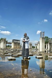 Reflection of woman standing on water