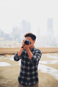 Young man photographing