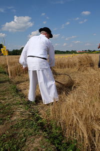 Full length of man standing on field against sky